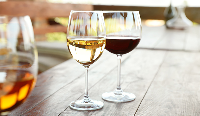 A bottle of wine bring poured into a glass