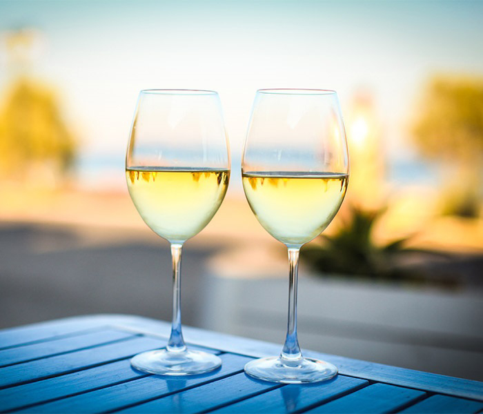 Glasses of white wine on an outside table