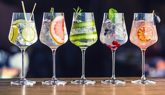 Glasses of spirts against a dark backdrop
