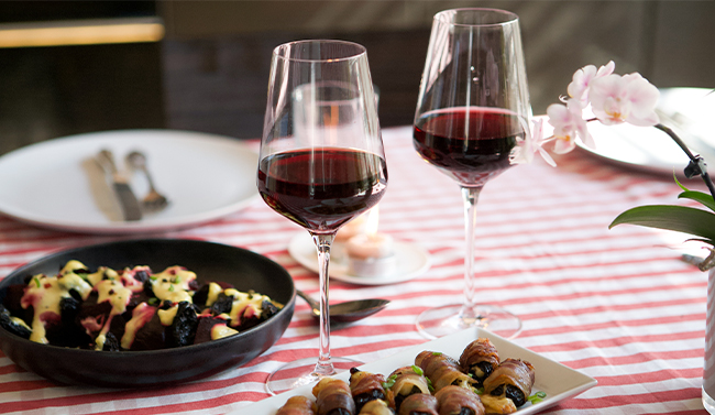 A glass of red wine in a vineyard