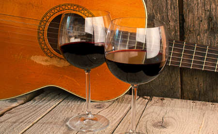 Two glasses of wines with a guitar