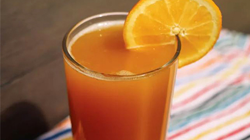 Beer cocktail with an orange peel