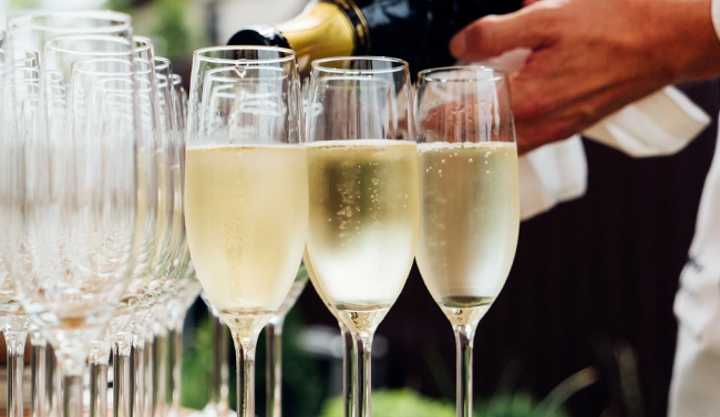 Bartender pouring Champagne into glasses